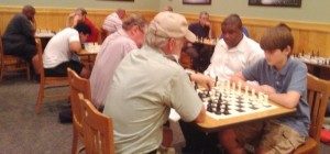 Competing at the first meeting of Madison-Huntsville Chess Club are Wally Malmburg playing Jenson Wilhelm, in foreground, Undrea Randolph, Luis Morenilla, Dr. Paul Mulqueen, Scott Edwards and Russel Freeman.